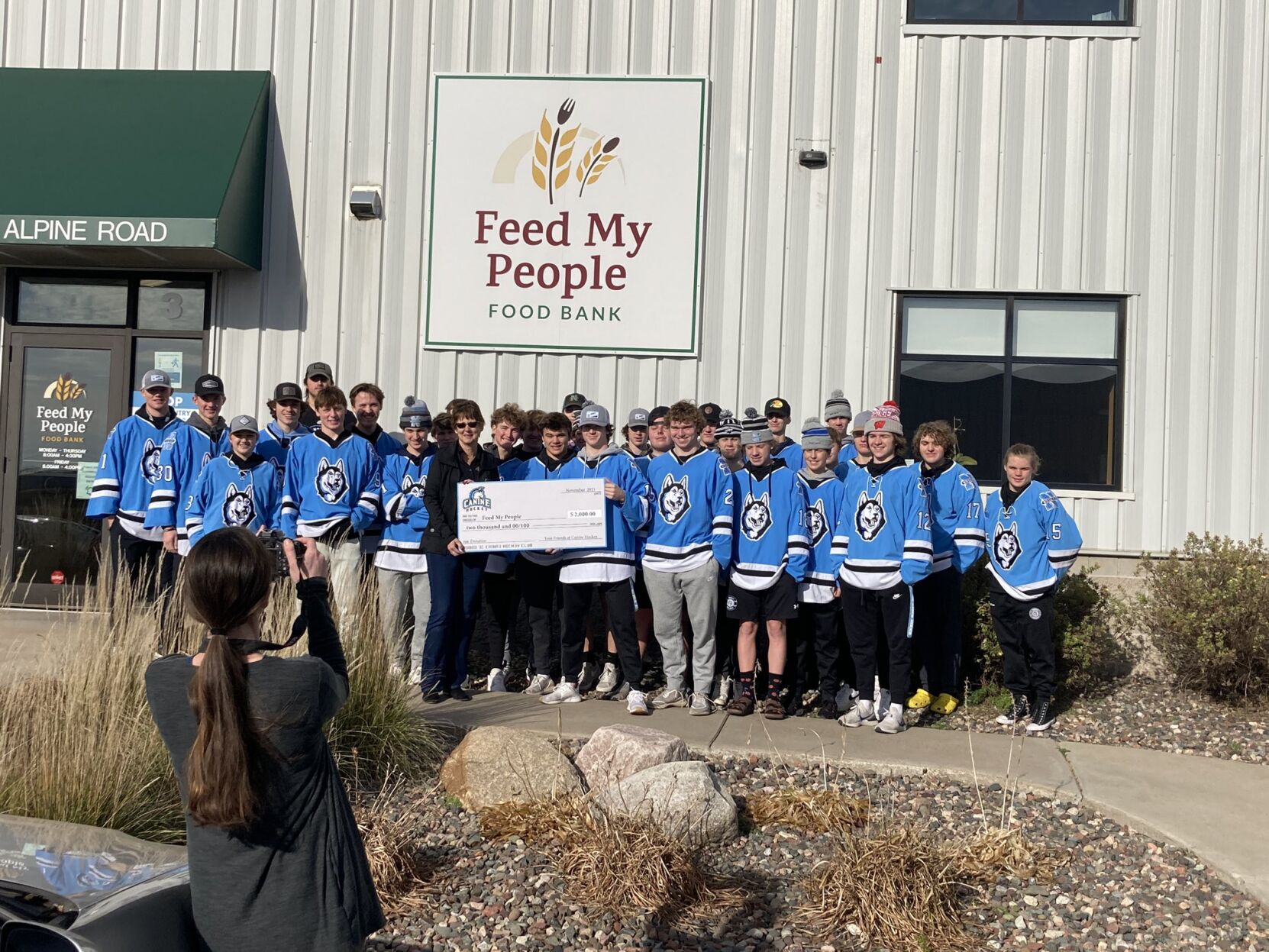 112421 North hockey presents check to Feed My People Food Bank